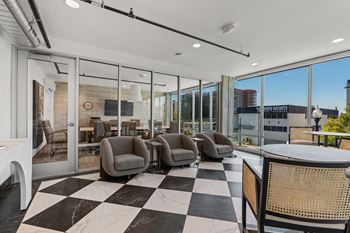 A black and white checkered floor in a room with glass walls.